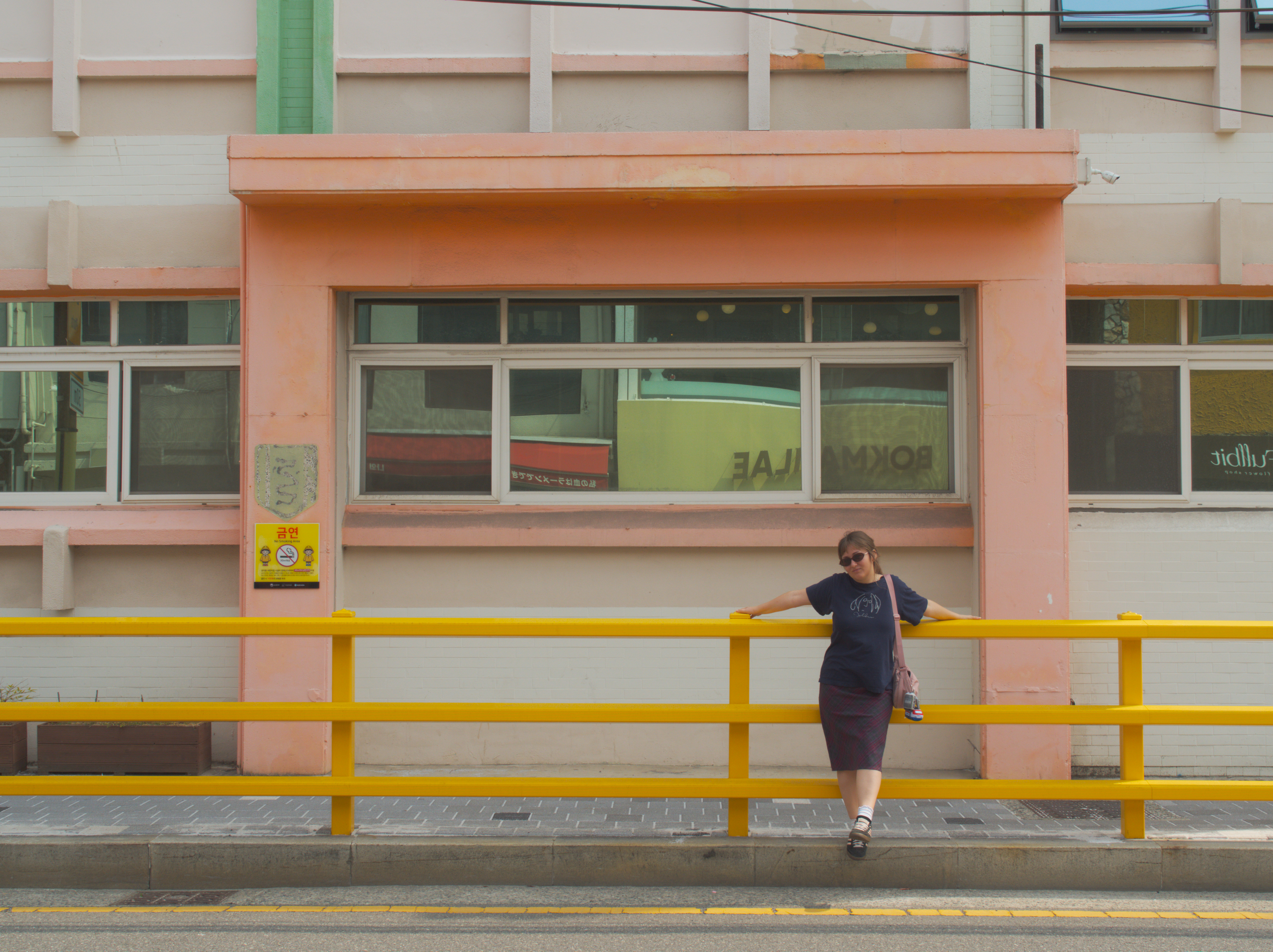 Alaina standing in front of a pink thing